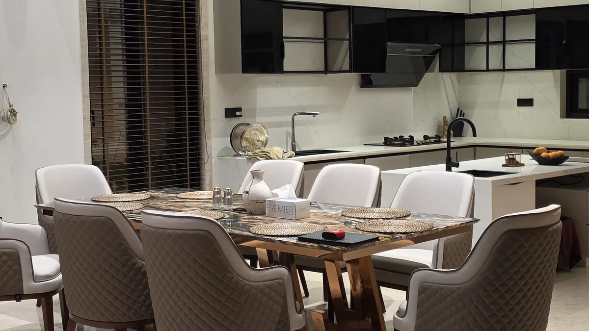 Custom 8-seater dining table with rose-gold base and marble top, quilted upholstered chairs — Flamingo Lifestyles Bengaluru villa project